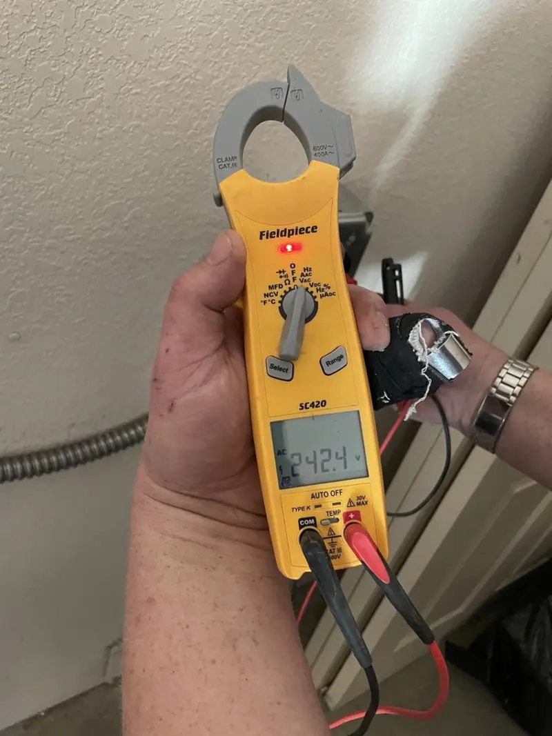 Voltage testing with clamp meter during Recessed Lighting Installation in Byron
